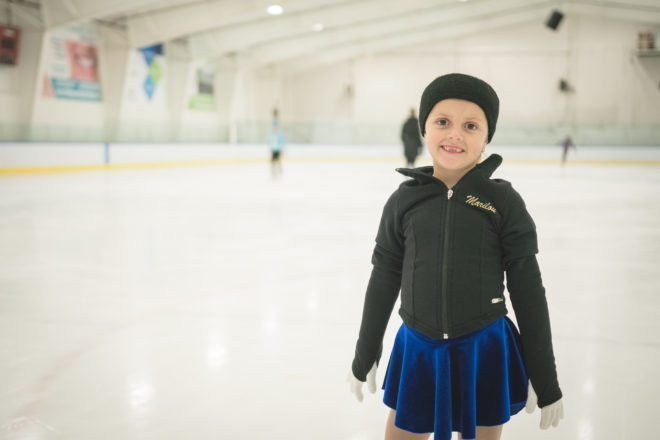 Child skating and smiling