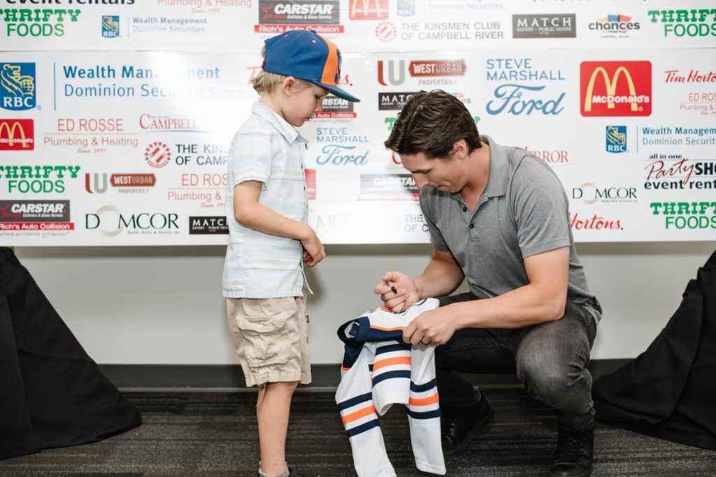 NHL Player Ryan Nugent-Hopkins signing jersey for CF fighter Kim Wood's Son at annual Rod Brind'Amour CF Golf Classic.
