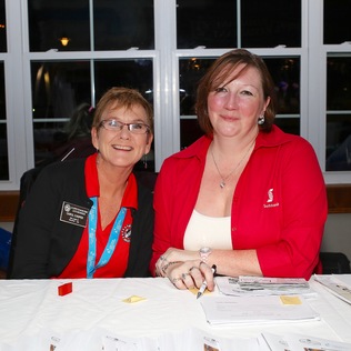 Two Scotiabank volunteers at a volunteer table