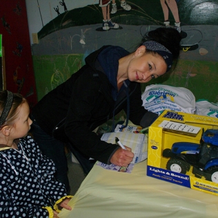 A woman making a bid for a toy tractor