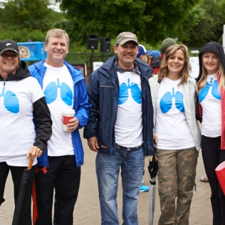a group of people with blue lung shirts