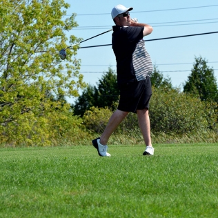 a golfer swinging from the fairway
