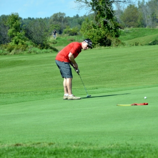 a golfer in the act of putting