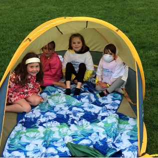 Four girls in a small tent