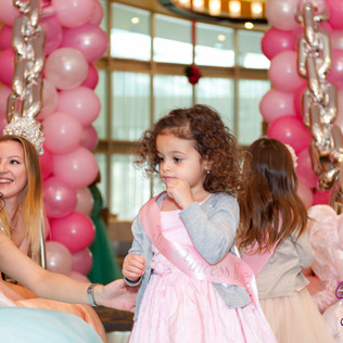 A toddler princess and three princesses