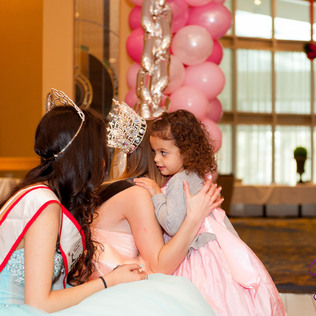 A princess hugs a toddler princess
