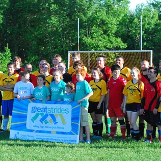 Soccer players posing with the Great Strides sign in the middle